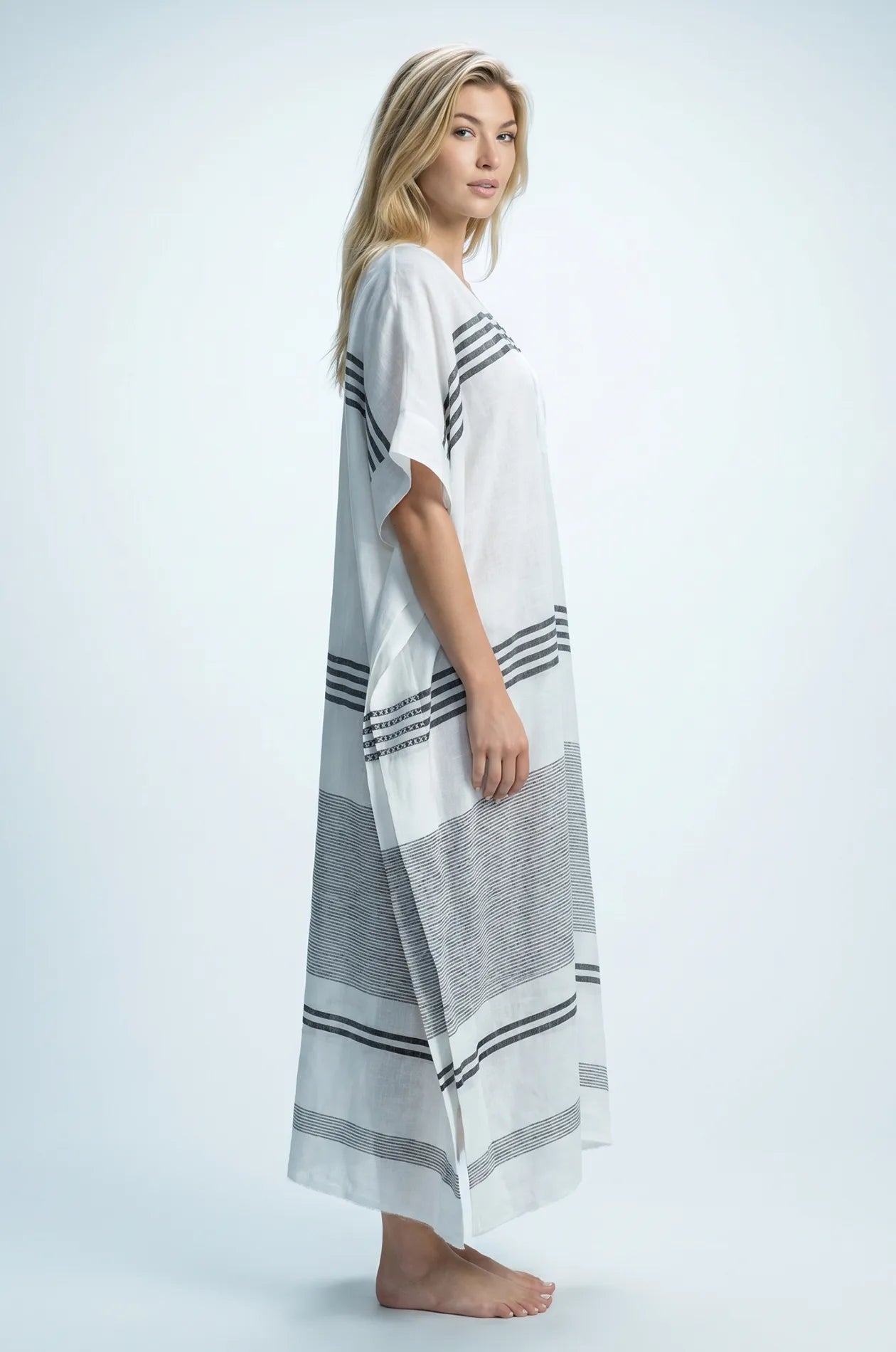 Side view of Naylara Dalia striped cotton kaftan showing maxi length and flowing silhouette