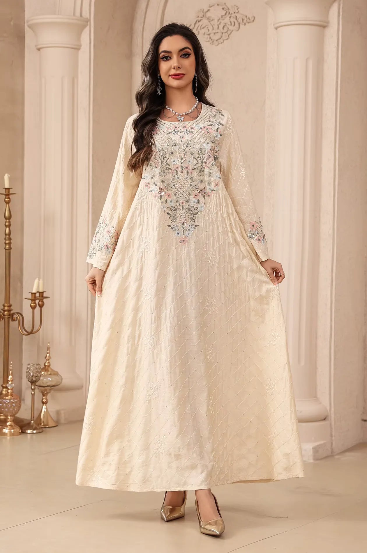 Model showcasing the flowy A-line silhouette of the beige Equis modest kaftan from the Naylara collection.