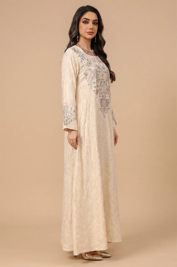 Side profile of a model wearing the beige Equis modest kaftan with bell sleeves and floral patterns.