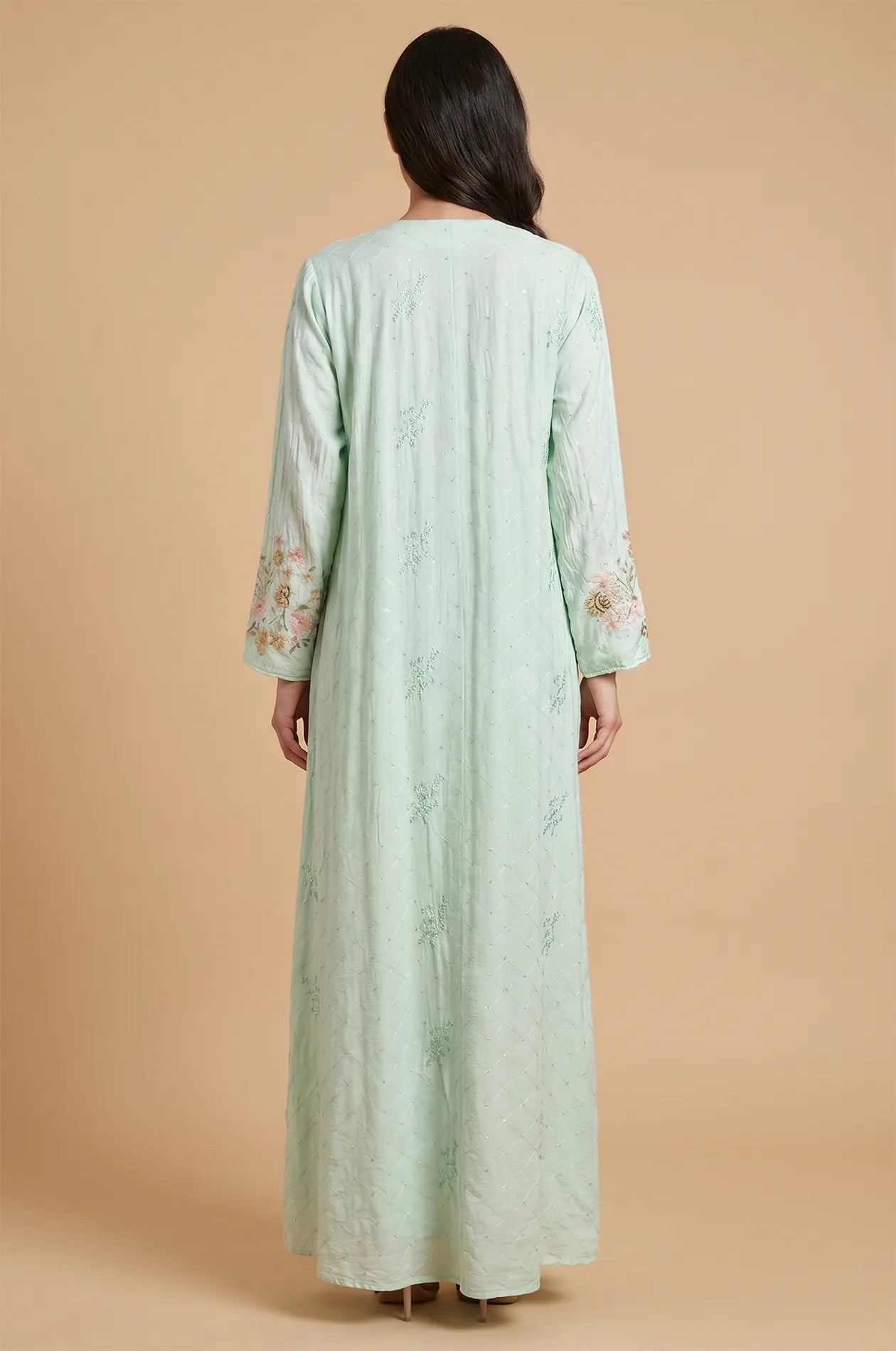 Back view of the light green Equis modest kaftan demonstrating the high-quality fabric drape and seamless finish.