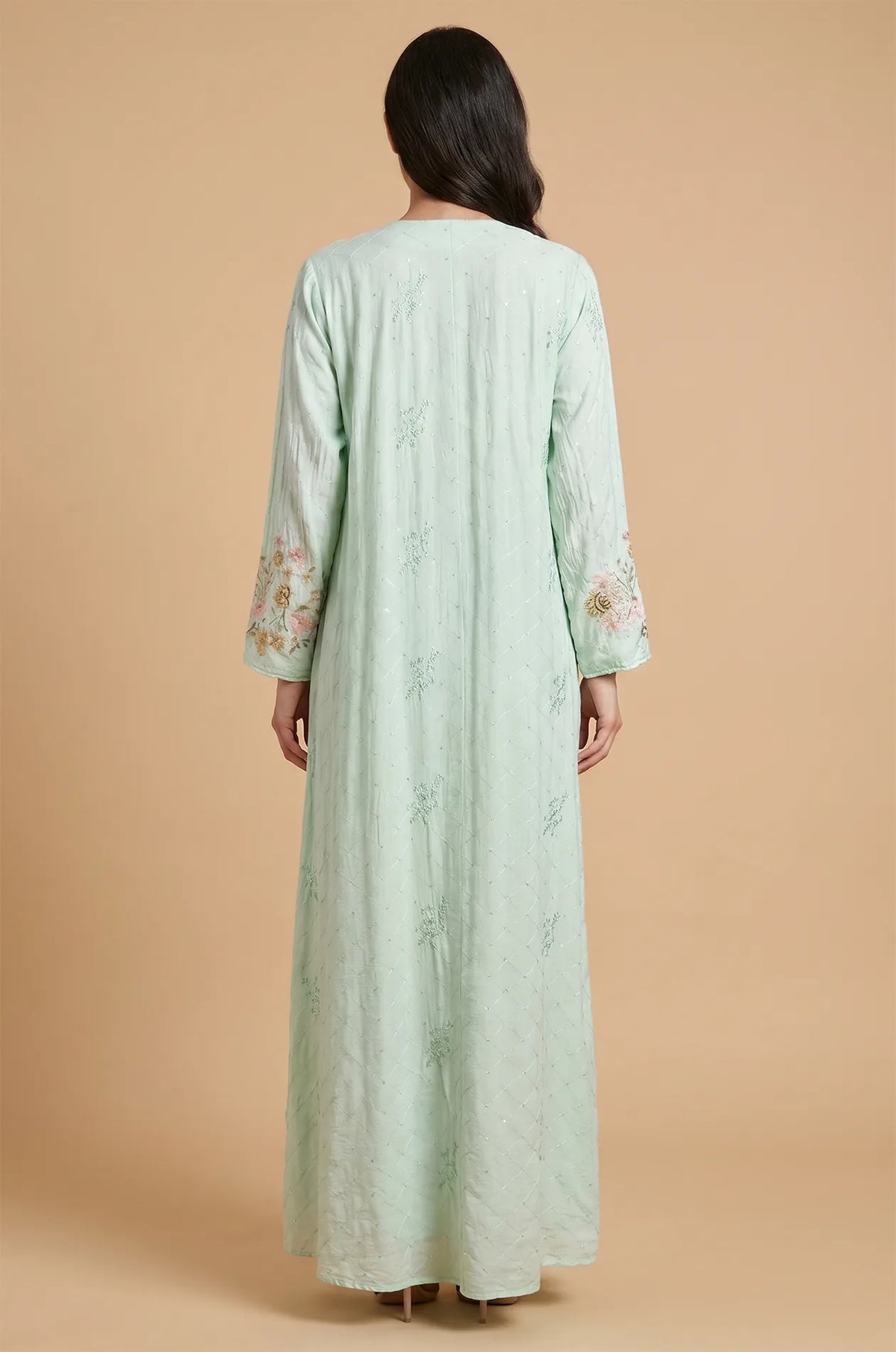 Back view of the light green Equis modest kaftan demonstrating the high-quality fabric drape and seamless finish.