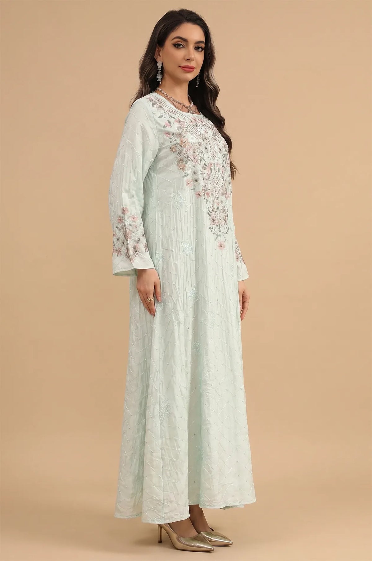 Side profile of the green Equis modest kaftan showcasing the flared bell sleeves and textured crepe fabric.