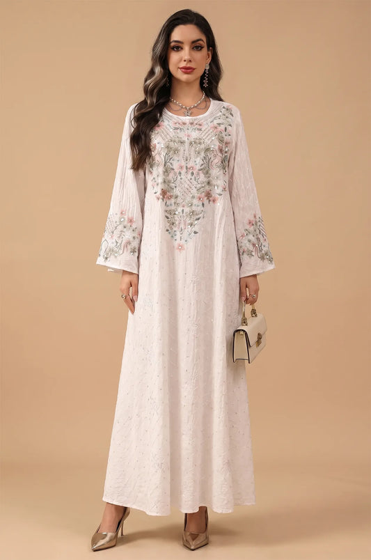A clean studio portrait of the white Equis modest kaftan showcasing its graceful A-line silhouette.
