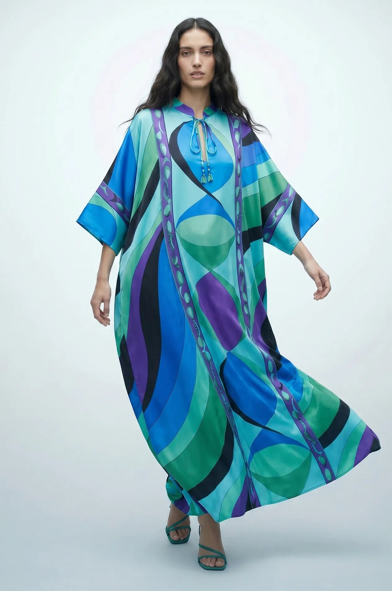 Naylara Erica blue geometric satin kaftan in motion — tassel neckline detail visible