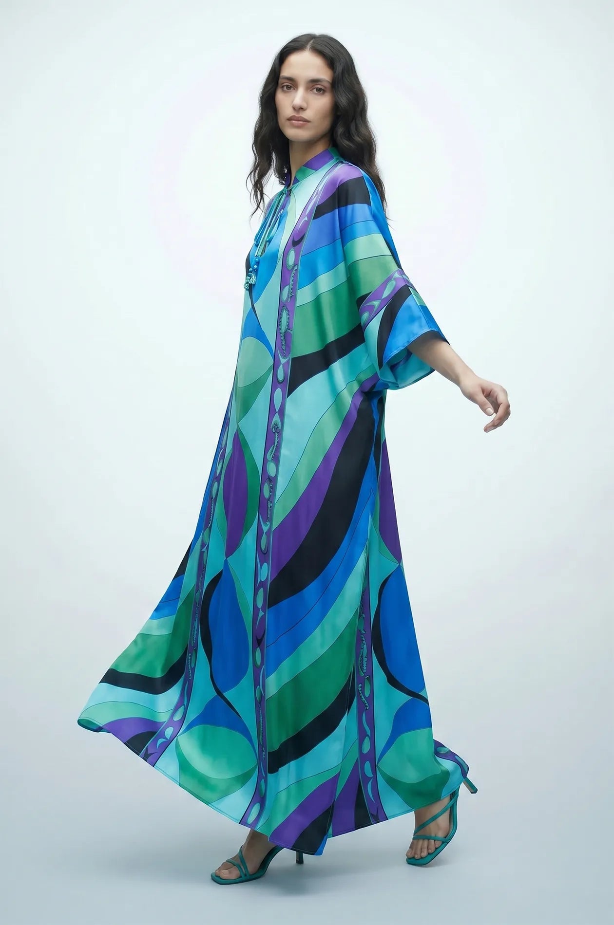 Naylara Erica flowing satin kaftan with blue green geometric print — side motion shot