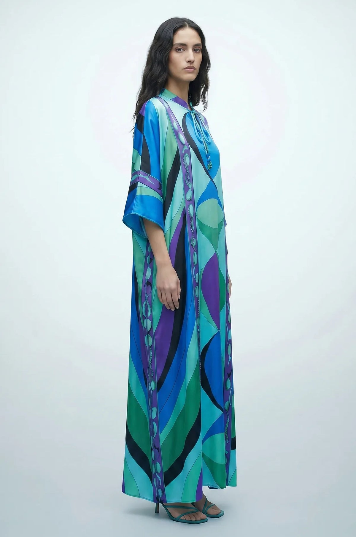Side view of Naylara Erica tassel kaftan cover up in blue psychedelic print satin