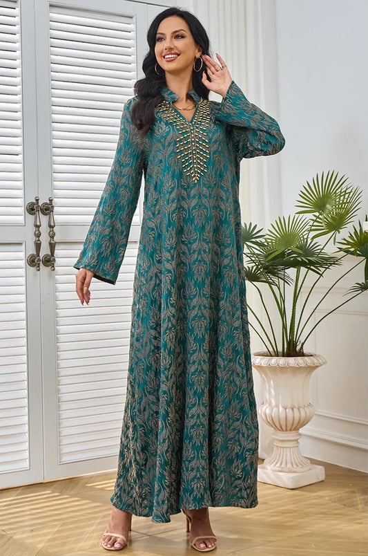 Model posing in the Farah emerald green kaftan by Naylara in a studio setting.