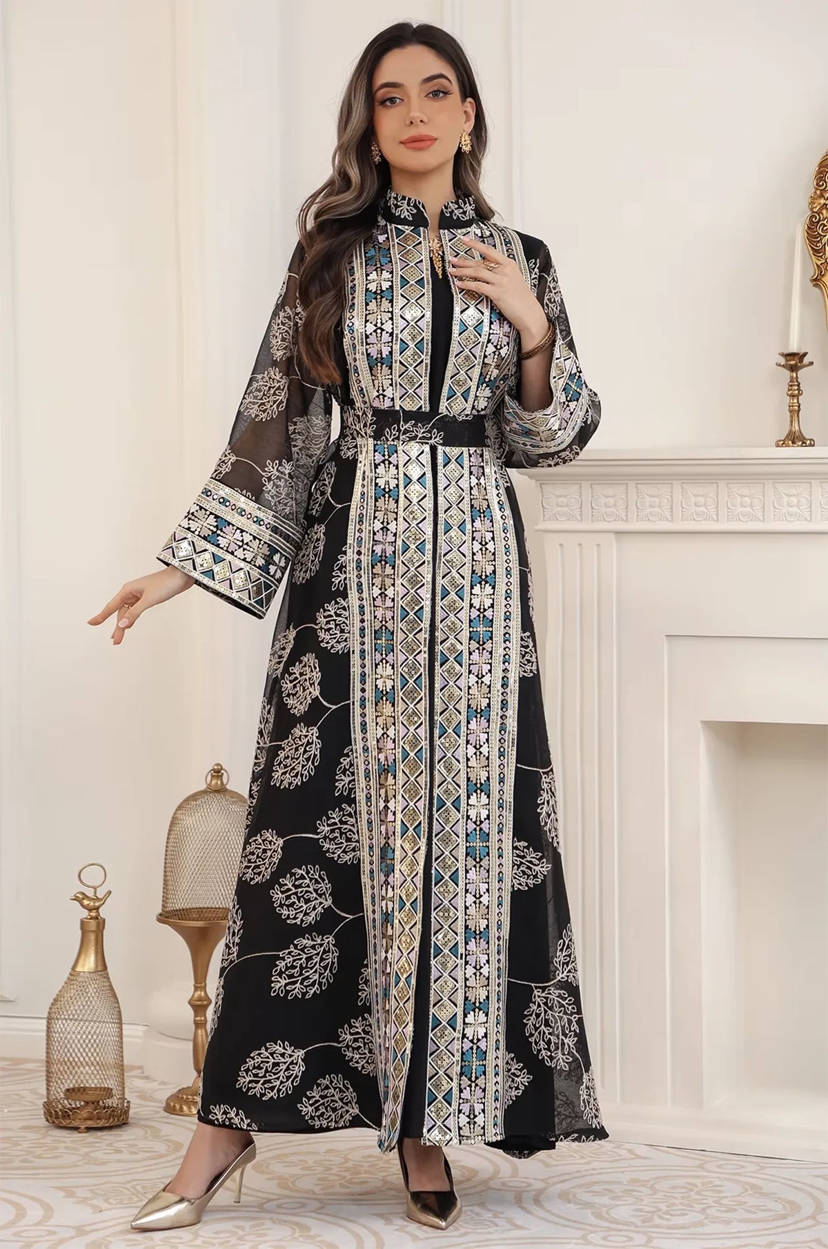 Full-length view of the black Gienah chic kaftan, showing the elegant floor-length drape and sheer embroidered sleeves.