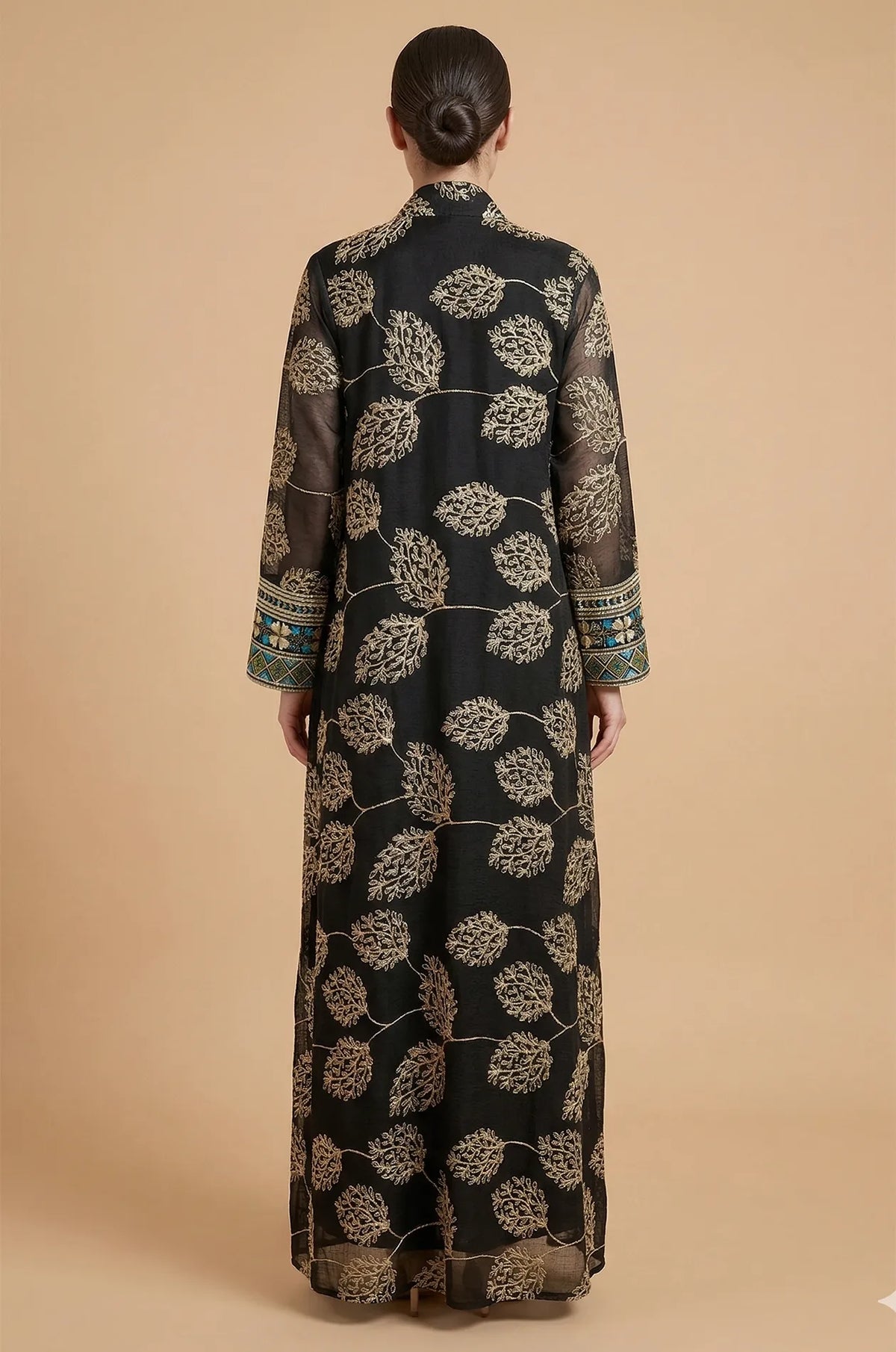 Back view of the Gienah chic kaftan in black, displaying the sophisticated gold-thread floral patterns across the shoulders and back.