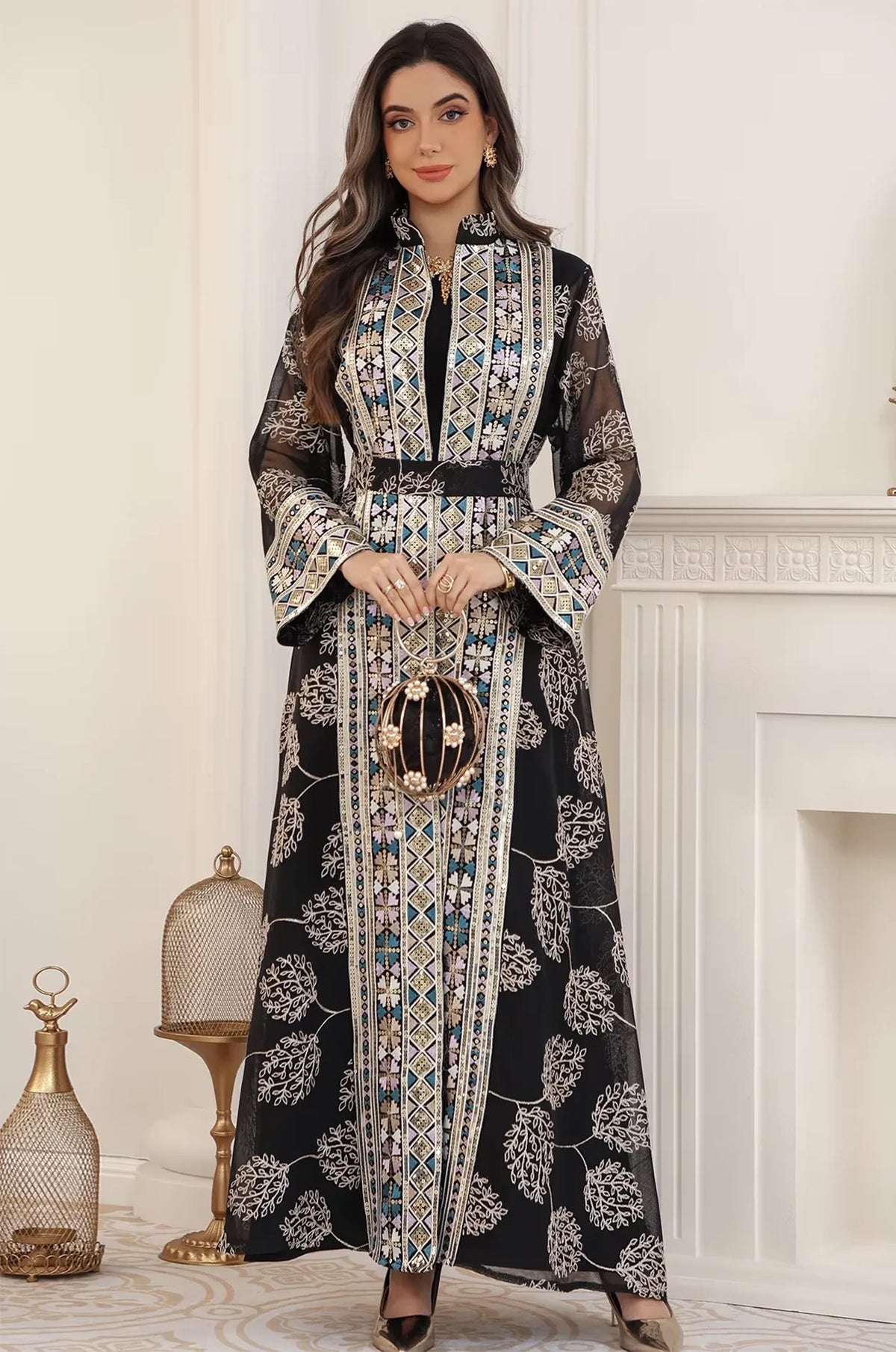 Elegant styling of the Gienah black chic kaftan paired with a pearl evening bag, perfect for a formal party or wedding.