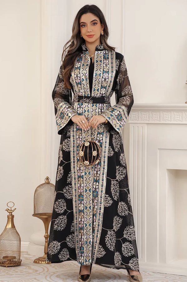 Elegant styling of the Gienah black chic kaftan paired with a pearl evening bag, perfect for a formal party or wedding.
