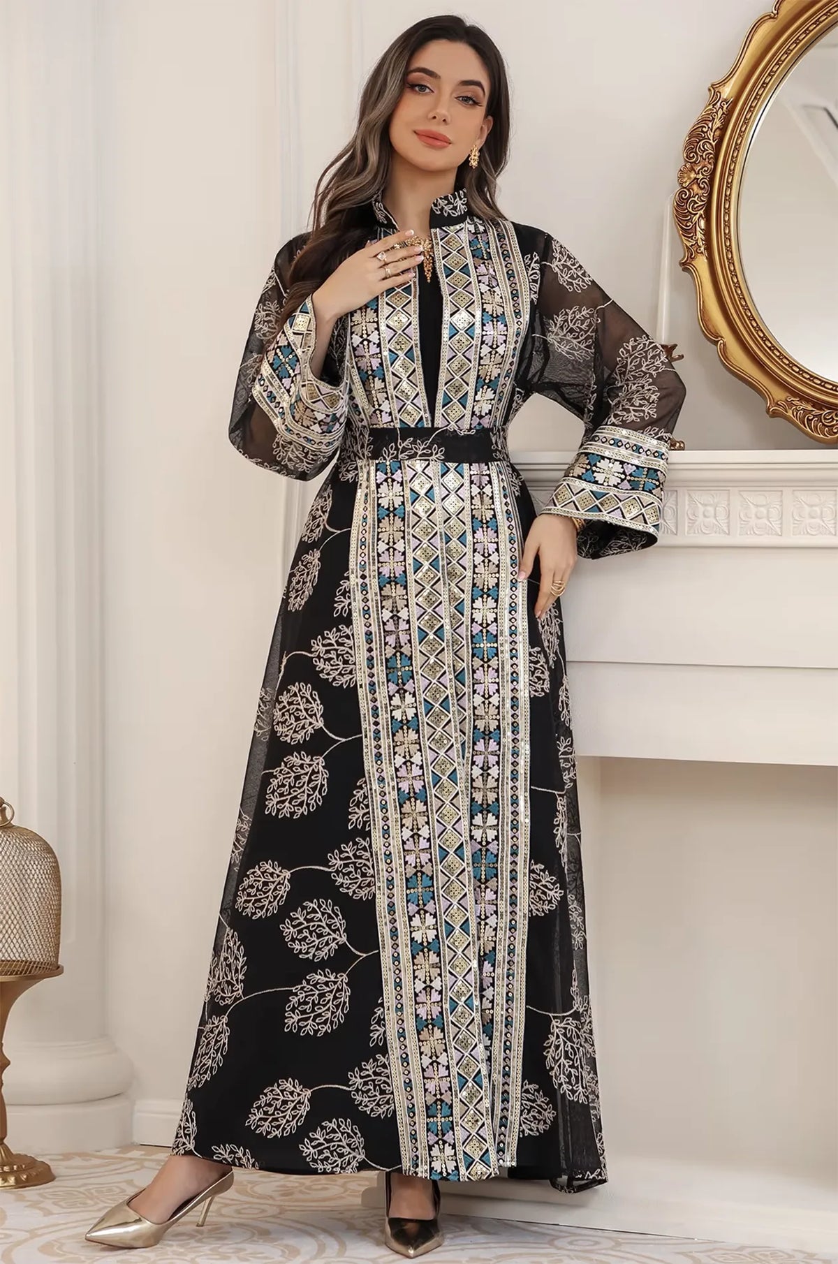 Lifestyle shot of the Gienah chic kaftan in black, featuring hand-placed sequins and a shimmering geometric border.