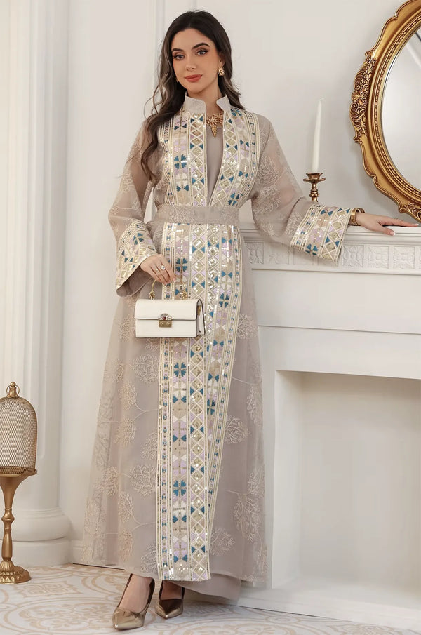 Modern styling of the apricot beige Gienah chic kaftan paired with a designer white handbag for an evening party.