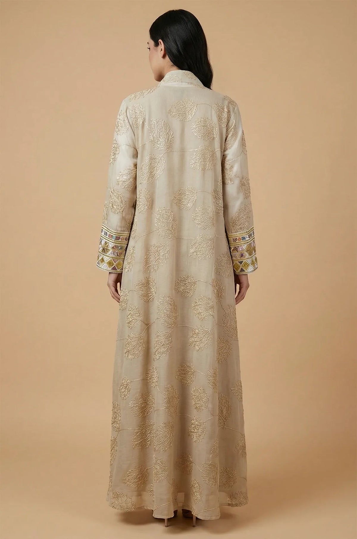 Back view of the apricot beige Gienah chic kaftan showing the elegant sheer fabric and intricate floral gold thread patterns.