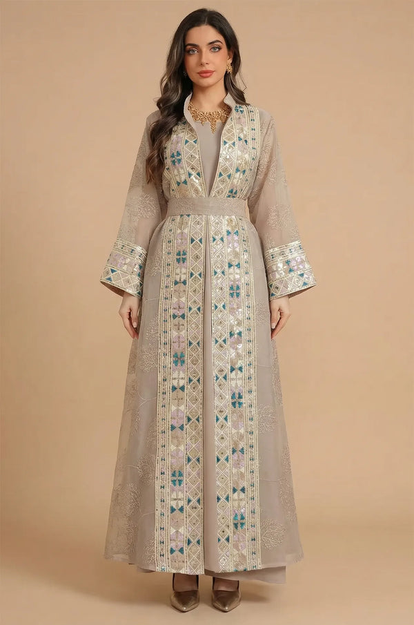 Full front view of the Gienah chic kaftan in apricot beige by Naylara, featuring gold embroidery and a matching belt.