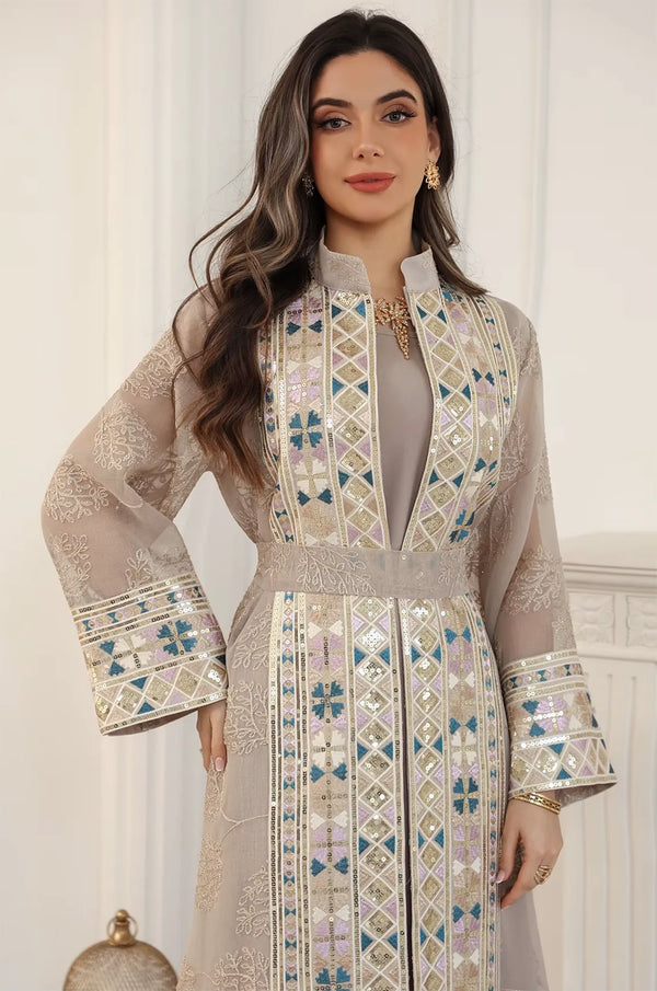 Detailed view of the artisanal embroidery and mosaic beadwork on the apricot beige Gienah chic kaftan by Naylara.