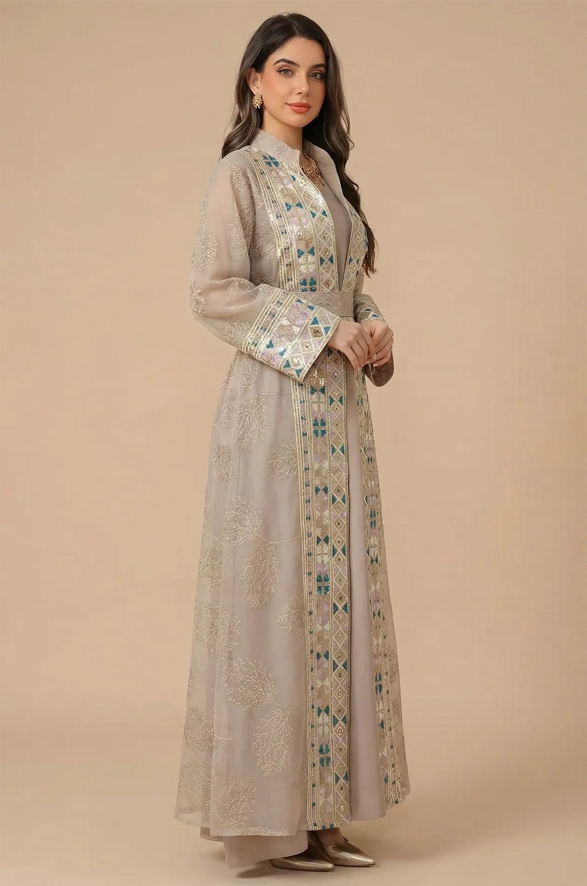 Side profile of a model wearing the Gienah chic kaftan in apricot beige, showcasing the floor-length fluid silhouette.