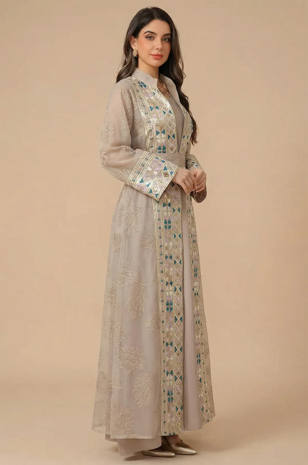 Side profile of a model wearing the Gienah chic kaftan in apricot beige, showcasing the floor-length fluid silhouette.