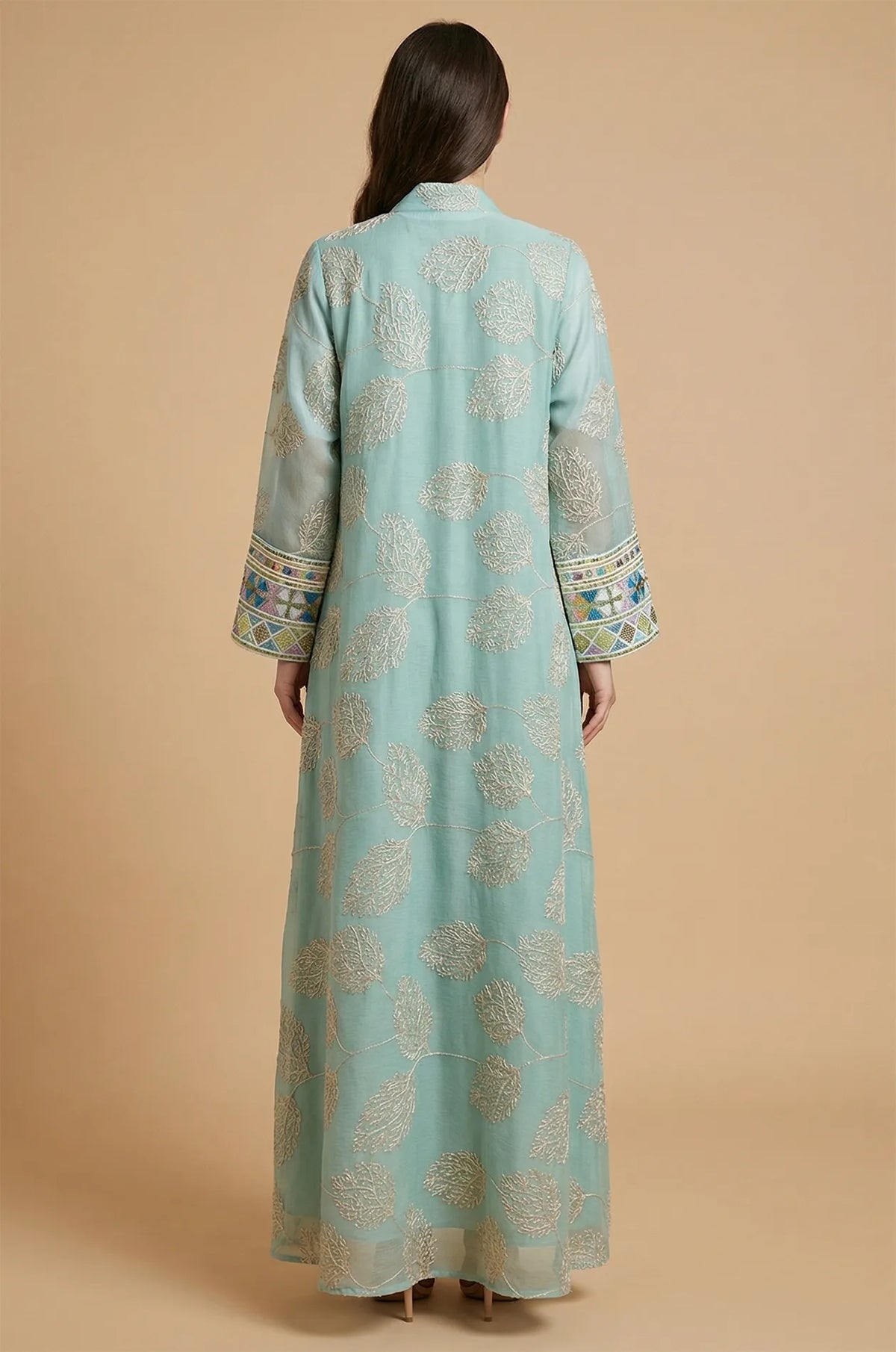 The elegant back view of the light green Gienah chic kaftan showcasing intricate silver-thread embroidery on sheer fabric.