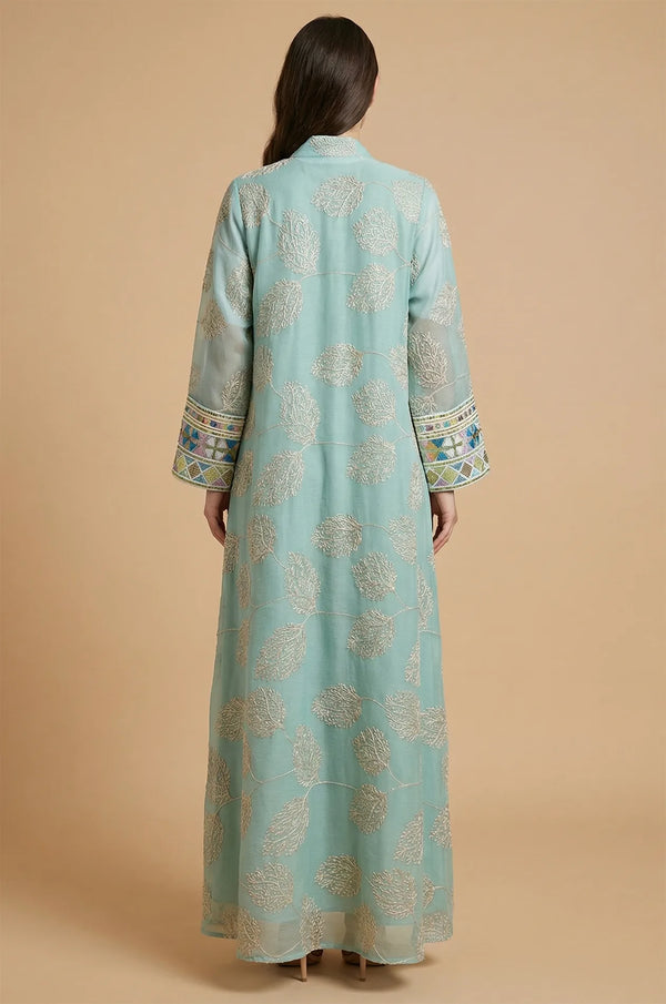 The elegant back view of the light green Gienah chic kaftan showcasing intricate silver-thread embroidery on sheer fabric.