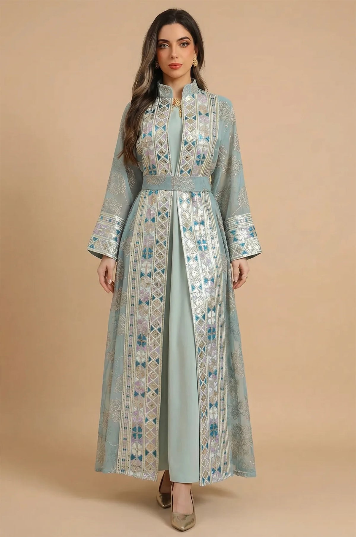 A full-length front view of the Gienah chic kaftan in light green by Naylara, featuring silver leaf embroidery and a belted waist.