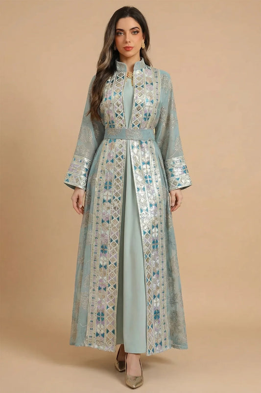 A full-length front view of the Gienah chic kaftan in light green by Naylara, featuring silver leaf embroidery and a belted waist.