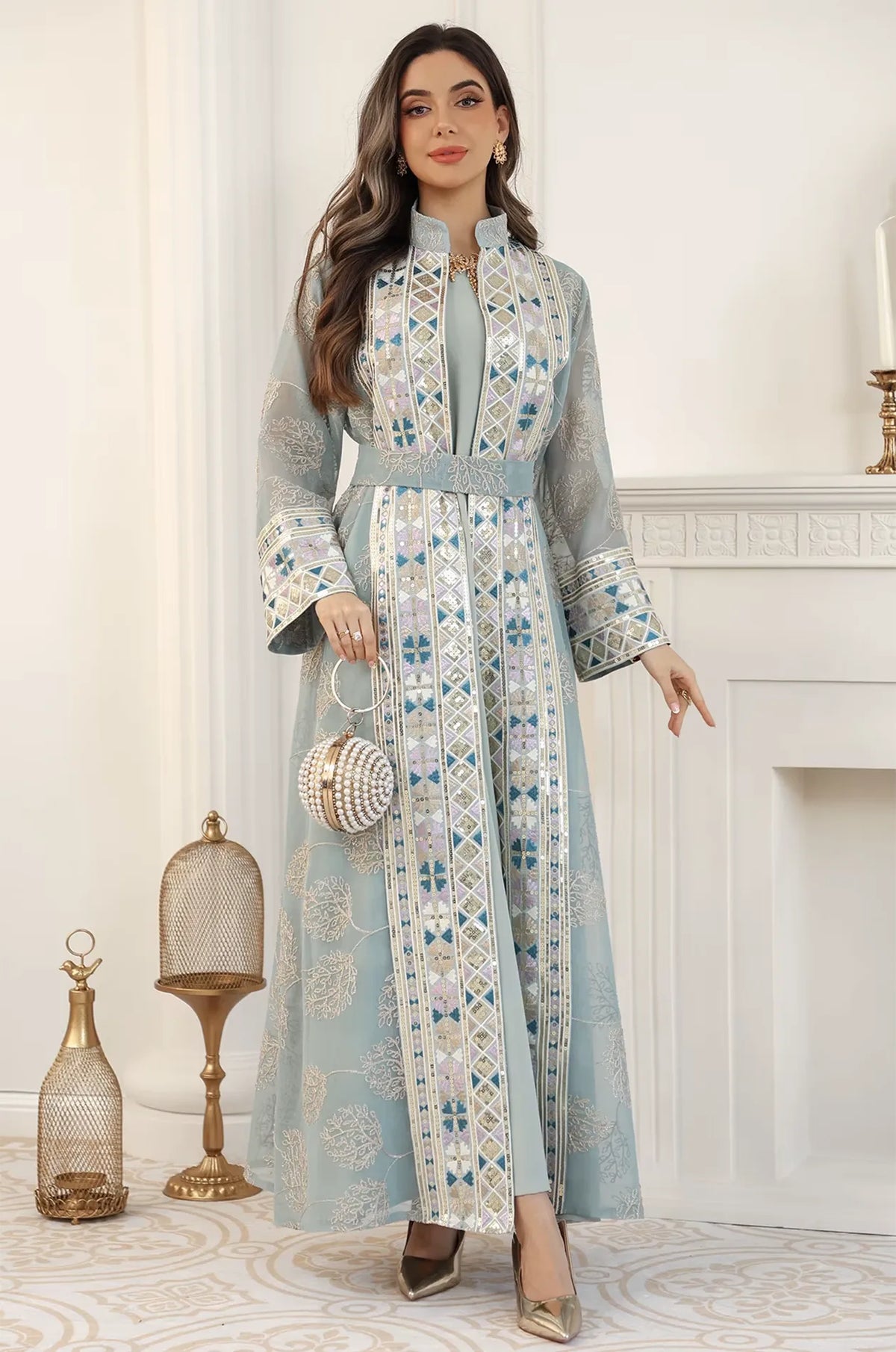 Elegant studio pose of the Gienah light green chic kaftan, showcasing the harmony of sage fabric and silver-toned embellishments.