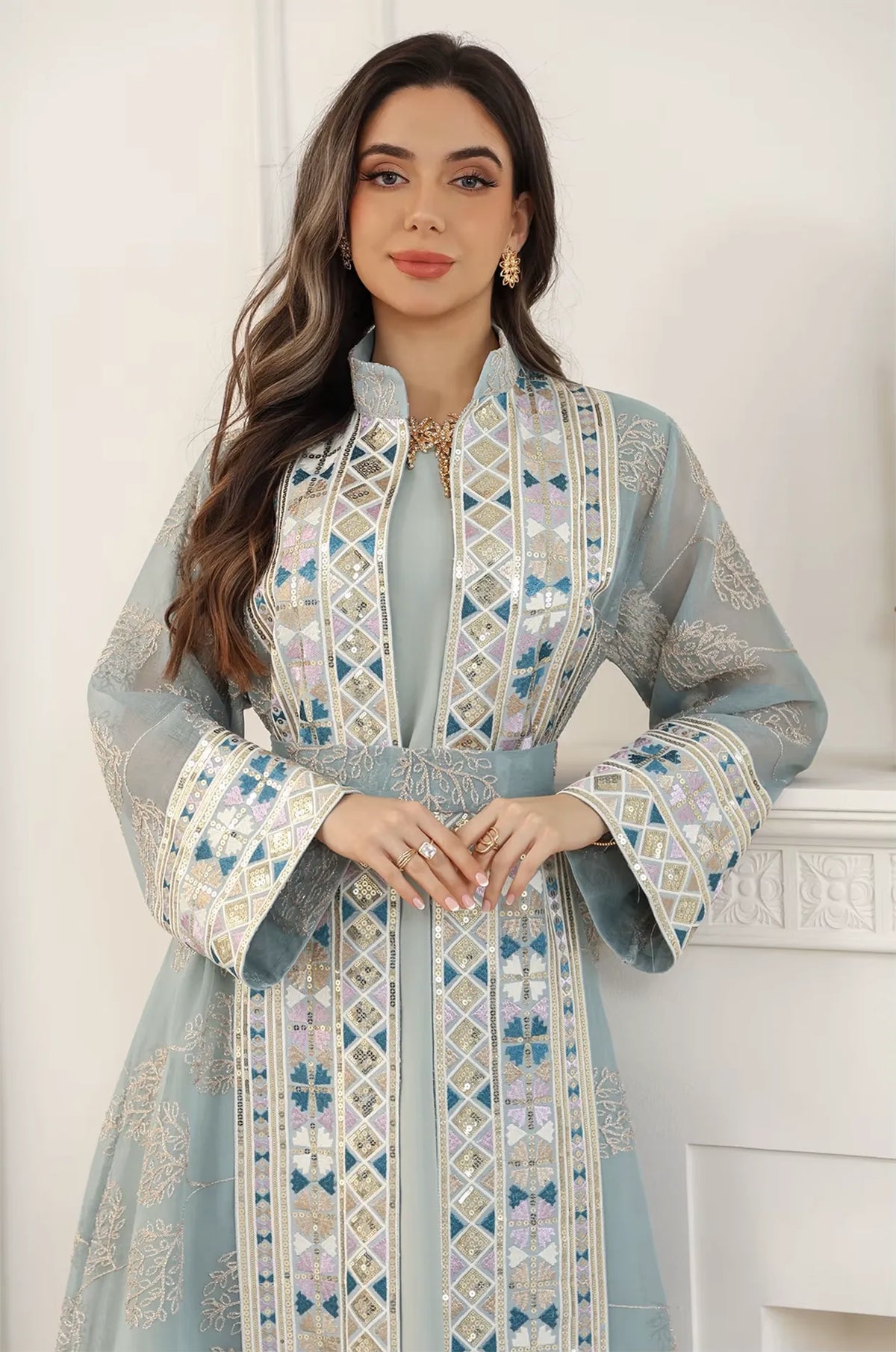 Mid-shot focus on the Gienah light green chic kaftan by Naylara, emphasizing the high-neck collar and embroidered waist belt.