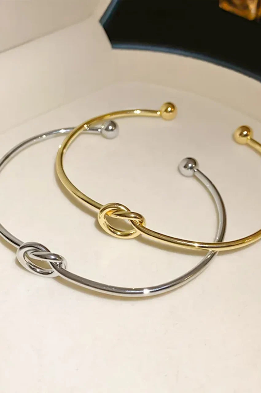 Set of gold and silver knot cuff bracelets for Kaftan accessorizing.