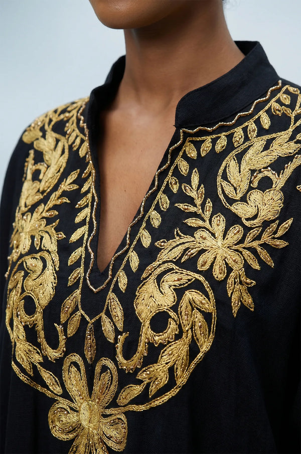 Naylara Halia black kaftan gold floral chest embroidery close-up with model smiling