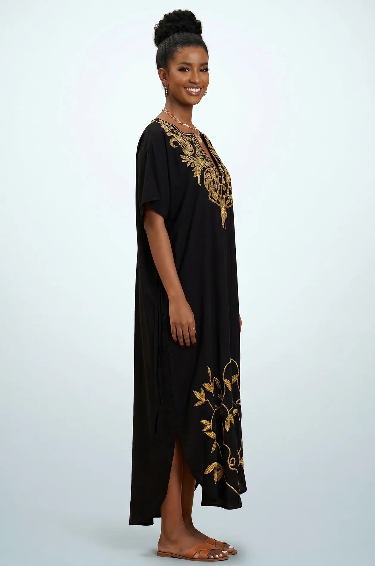 Side profile of Naylara Halia black gold embroidered kaftan showing hem leaf detail