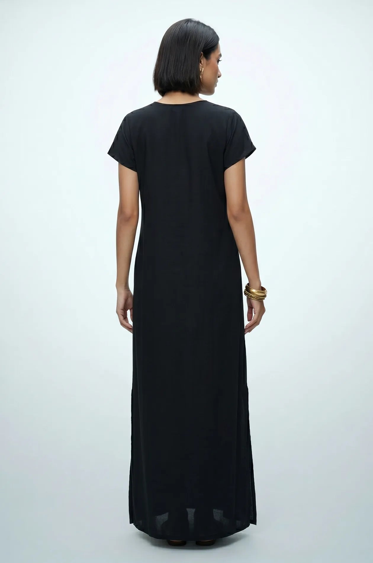 Back view of Naylara Iara black lightweight cotton kaftan — clean maxi silhouette