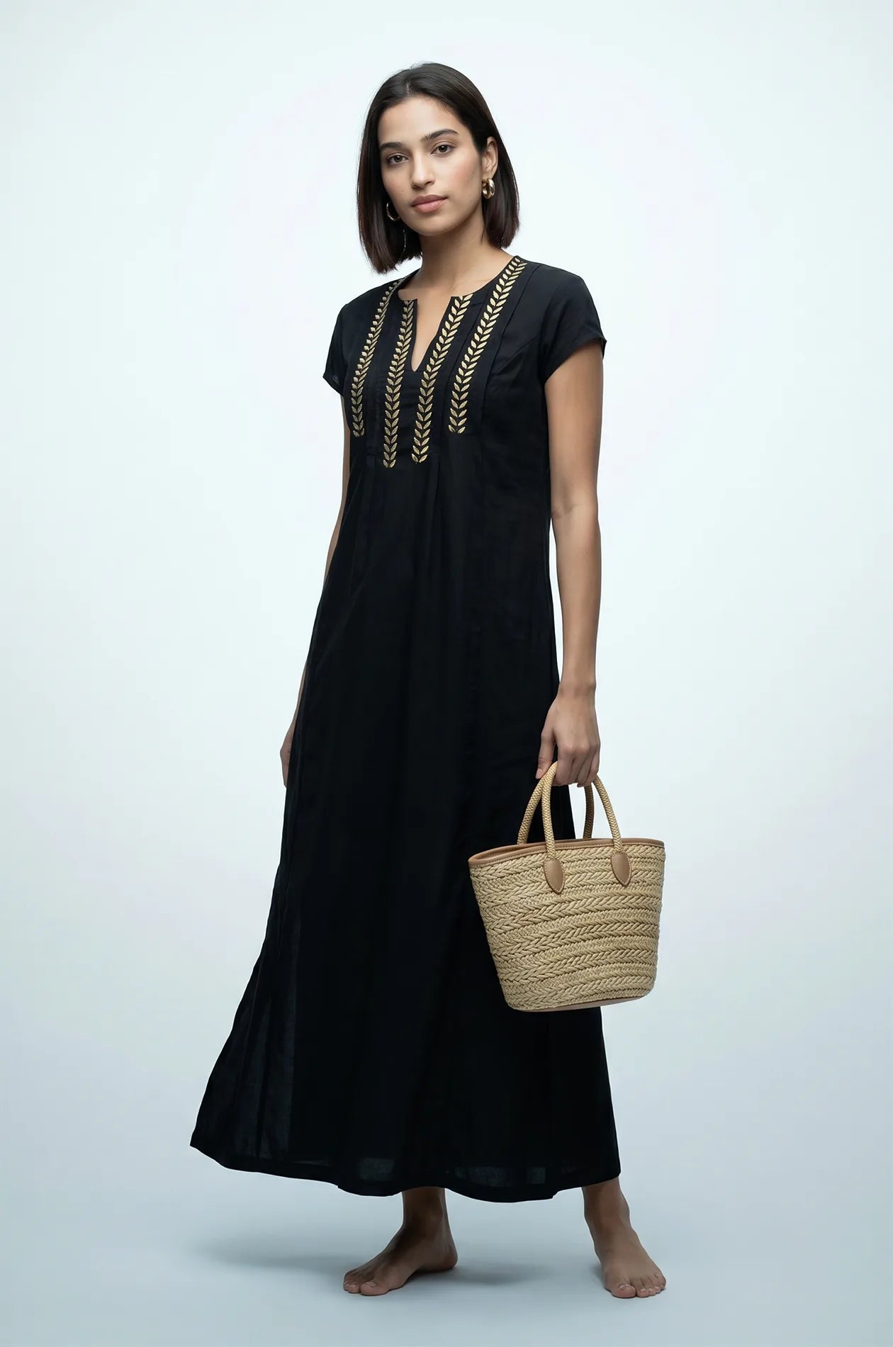 Naylara Iara black gold embroidered kaftan beach cover up styled with straw tote bag