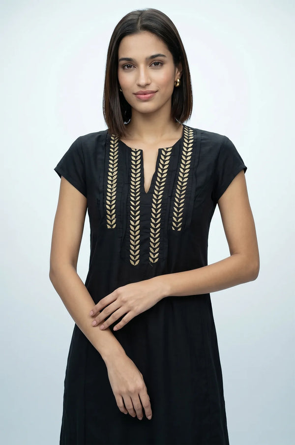 Close-up of Naylara Iara black kaftan V-neckline with gold leaf embroidered detail