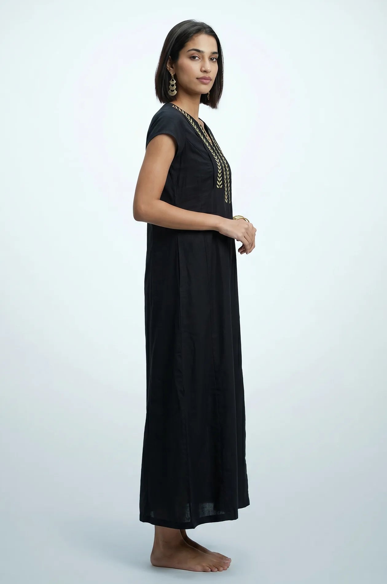 Naylara Iara black kaftan with gold leaf embroidery — side view, studio shot