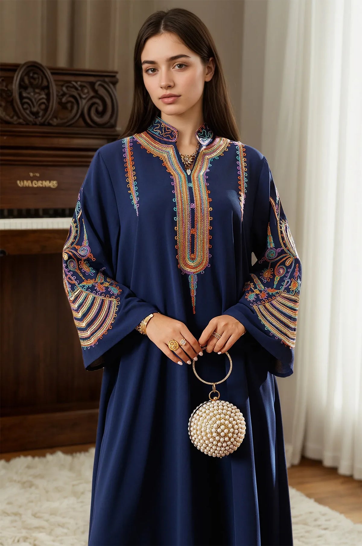 Styled view of the Inez Blue Kaftan paired with a pearl-embellished clutch for a formal evening look.
