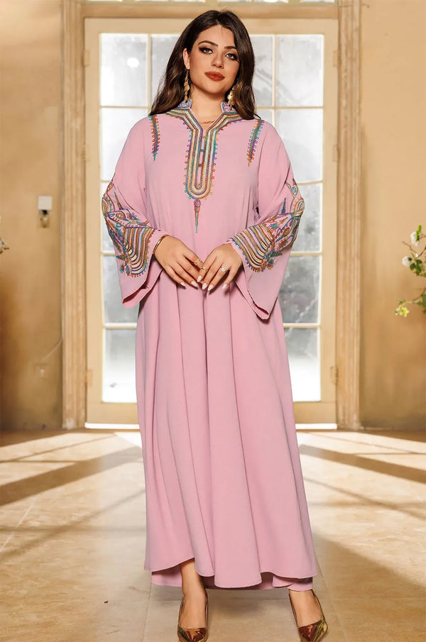 Front view of a model wearing the Inez Pink Jalabiya Kaftan in a sunlit indoor setting, showcasing the full-length silhouette.