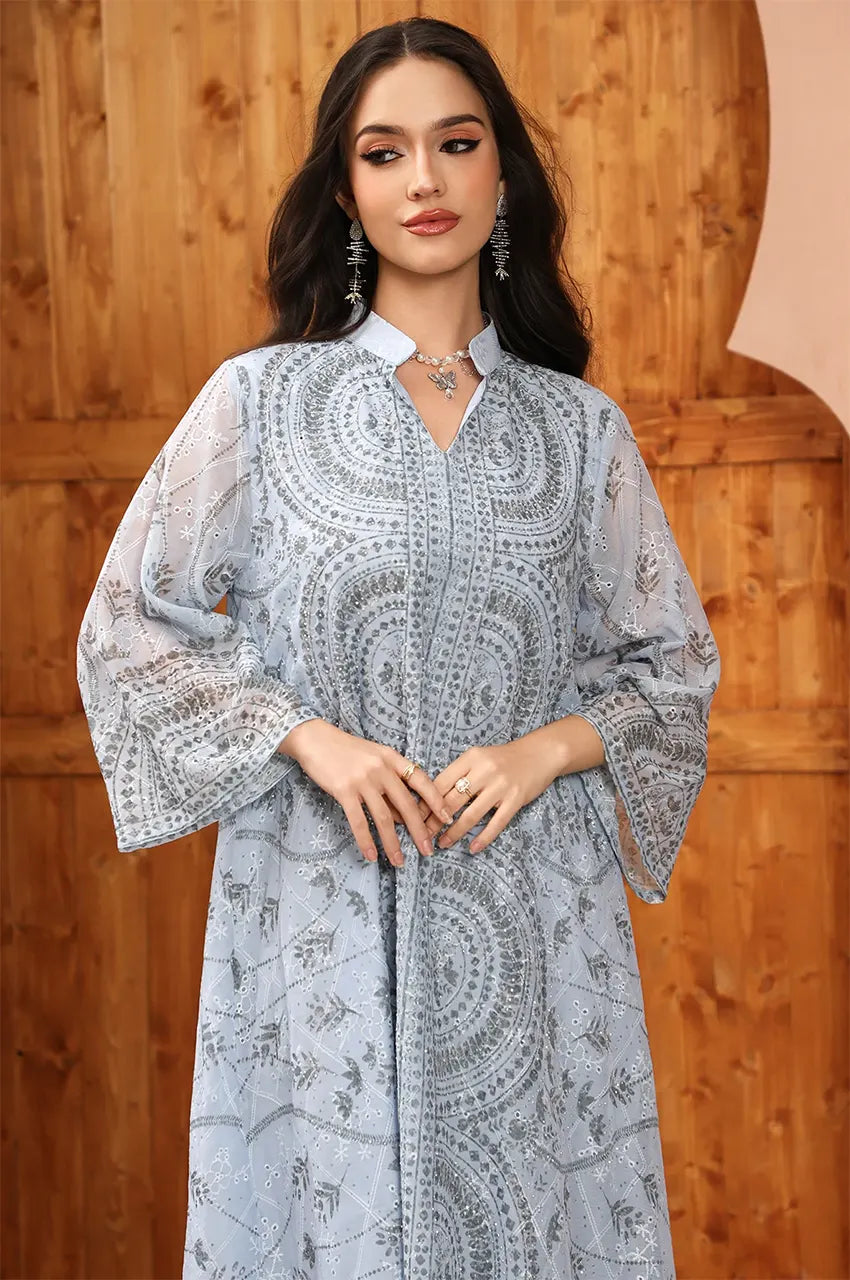 Close-up of the Kaly Light Blue sheer maxi kaftan's intricate embroidery and Aakad-inspired button detailing.