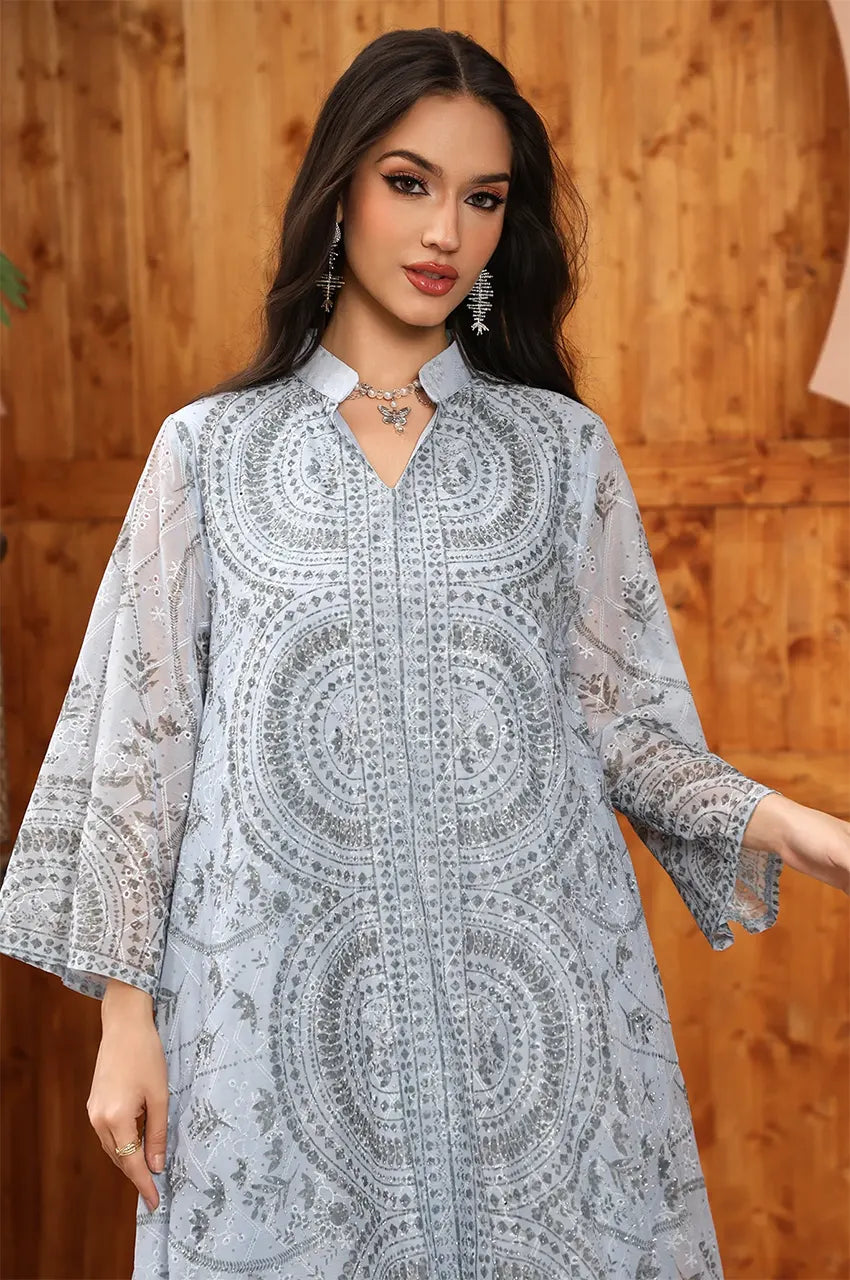 Waist-up view of the Kaly Light Blue sheer maxi kaftan showcasing the mandarin collar and high-density chest embroidery.