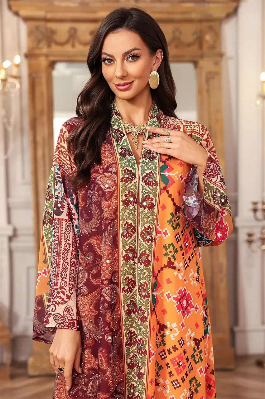 Mid-shot of the Kimia red Indian kaftan night dress focusing on the ornamental chest detailing and rich color palette.