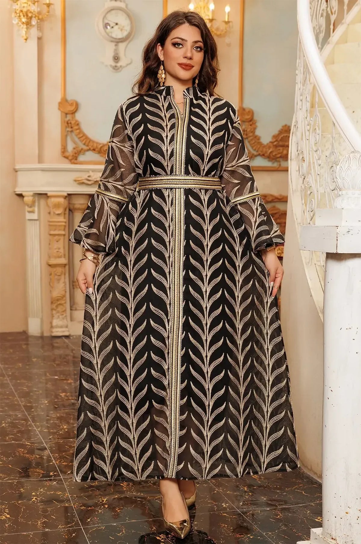 Full-length view of the Kitala Kaftan in black, showing the wide flowing skirt and the consistent metallic leaf embroidery throughout the garment.