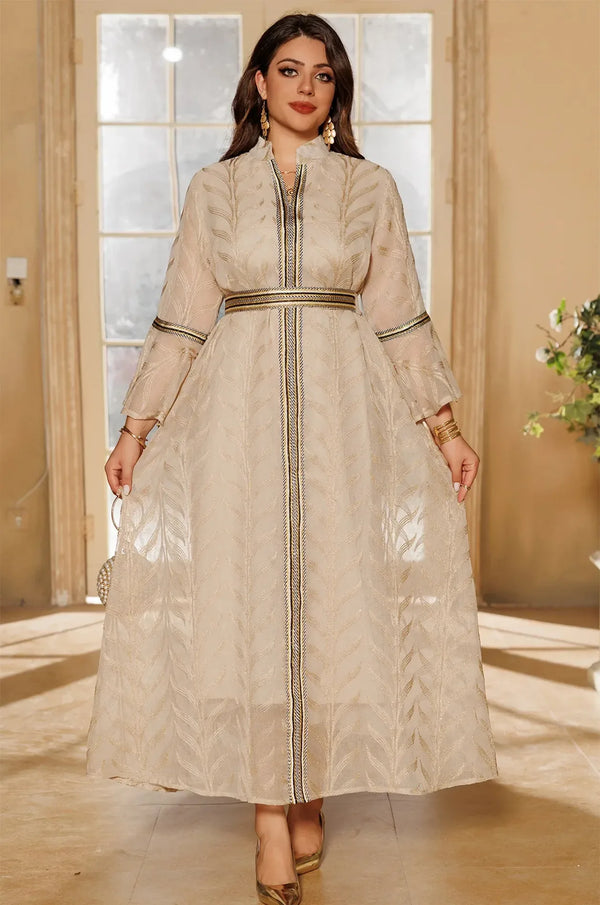 Full-body view of the ivory beige Kitala Kaftan by Naylara, styled with a jeweled gold belt and metallic heels for a formal look.