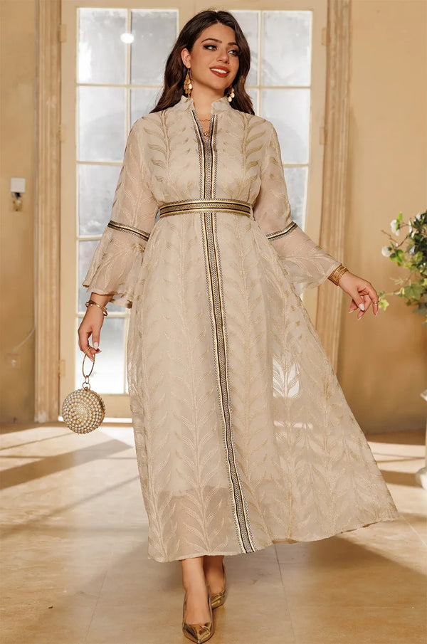 Full-length walking pose of a woman wearing the ivory beige Kitala Kaftan, emphasizing the light and airy sheer organza fabric.