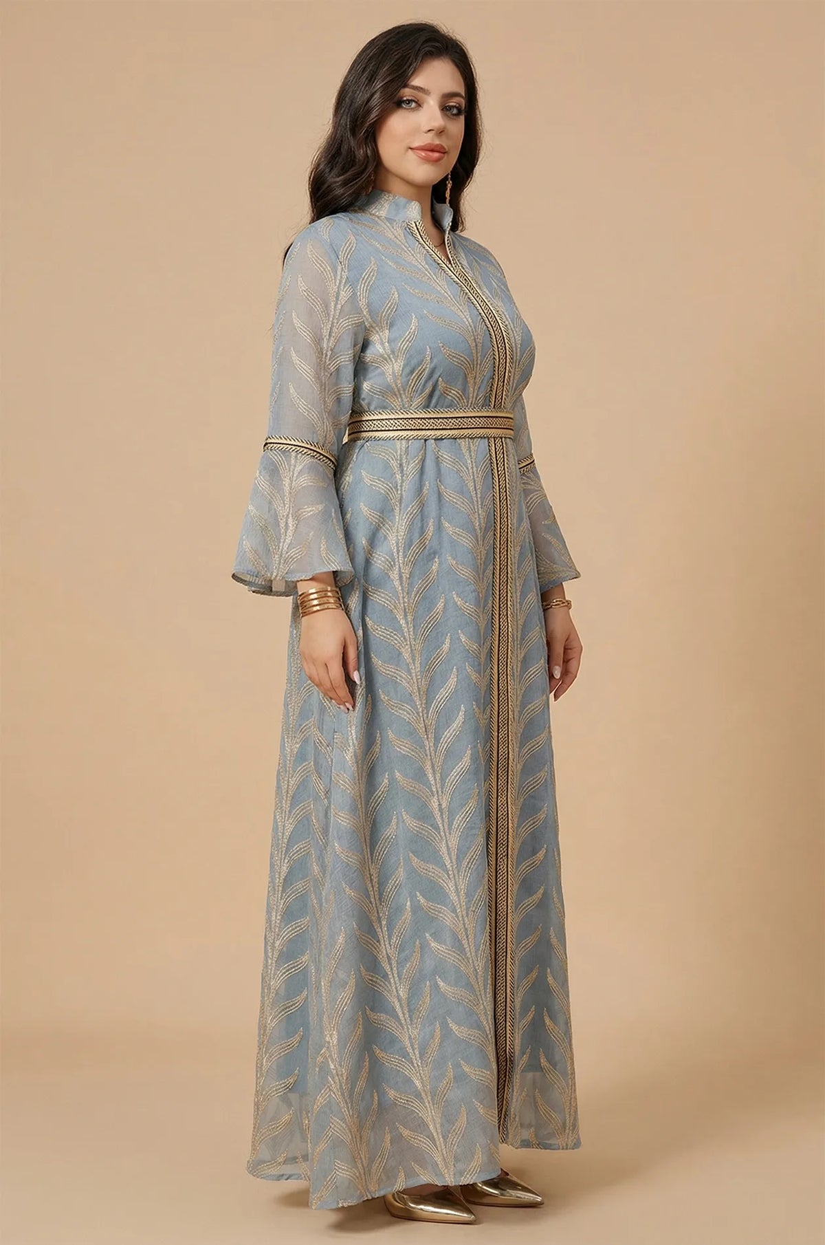 Side profile of a woman wearing the Kitala Elegant Moroccan Kaftan in light blue, showing the sheer fabric drape and intricate gold embroidered leaf pattern.
