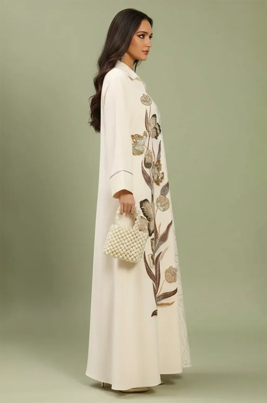 Side profile of the Lamiya beige a line kaftan dress highlighting the 3D floral sequins and structured sleeve detailing.