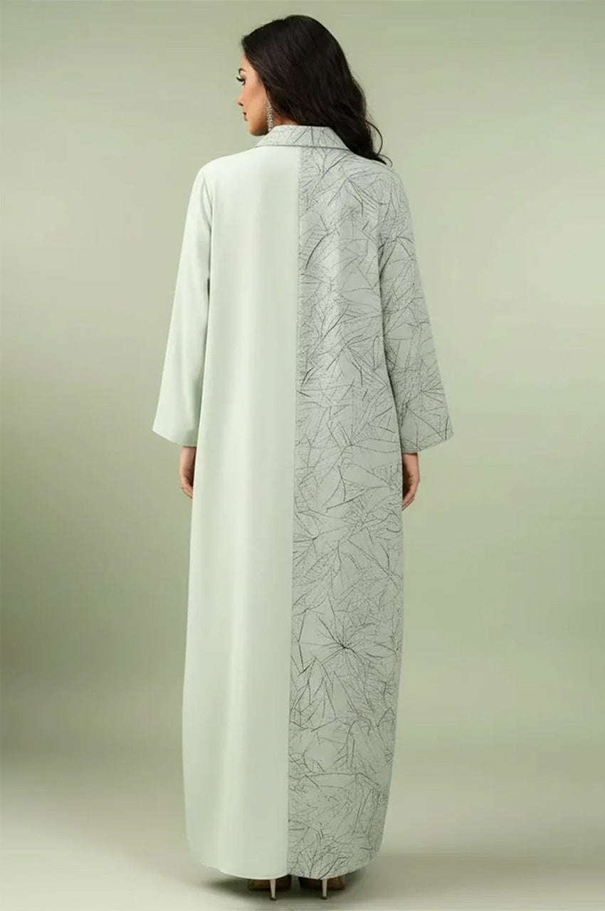 Modest Lamiya Green a line kaftan dress showcasing the graphic contrast between the sage base and the intricate leaf-motif panel.
