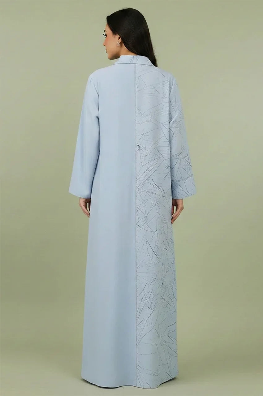 Back view of the Lamiya Light Blue a line kaftan dress highlighting the unique split design between premium matte crepe and a patterned leaf motif.