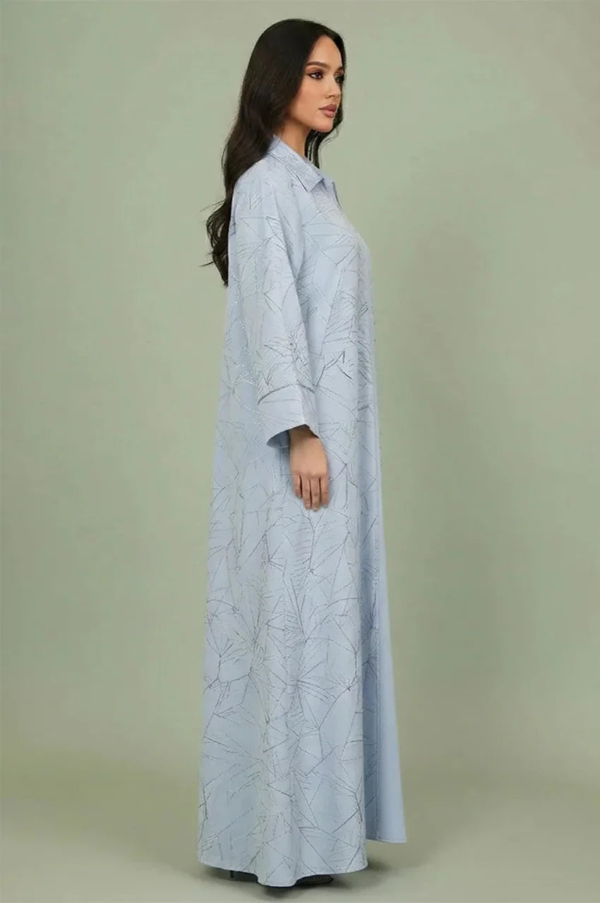 Side profile of the Lamiya Light Blue a line kaftan dress demonstrating the fluid A-line drape and intricate hand-applied sequin detailing.
