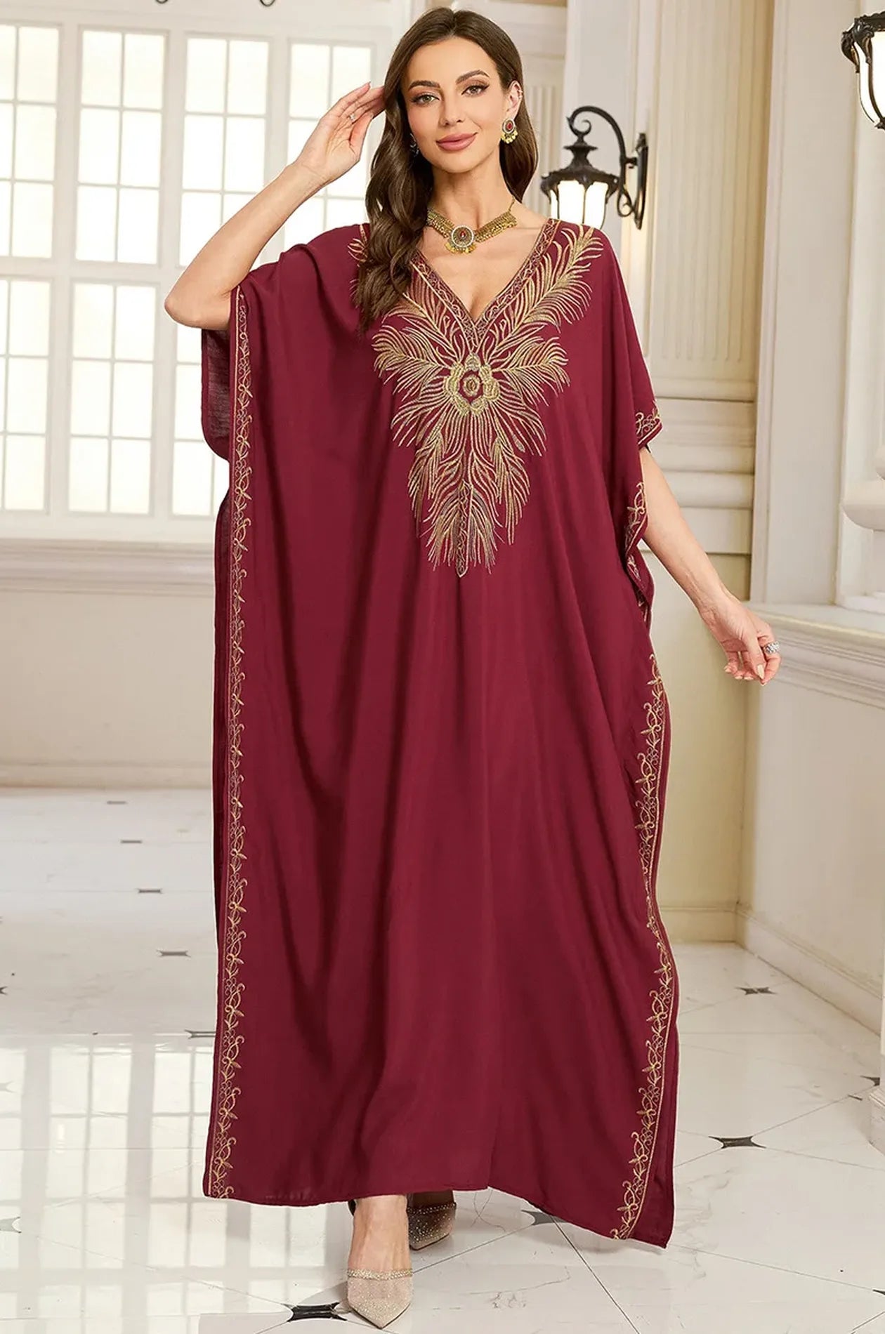 Naylara Laurel burgundy red kaftan with gold feather embroidery and gold jewelry — palace lifestyle
