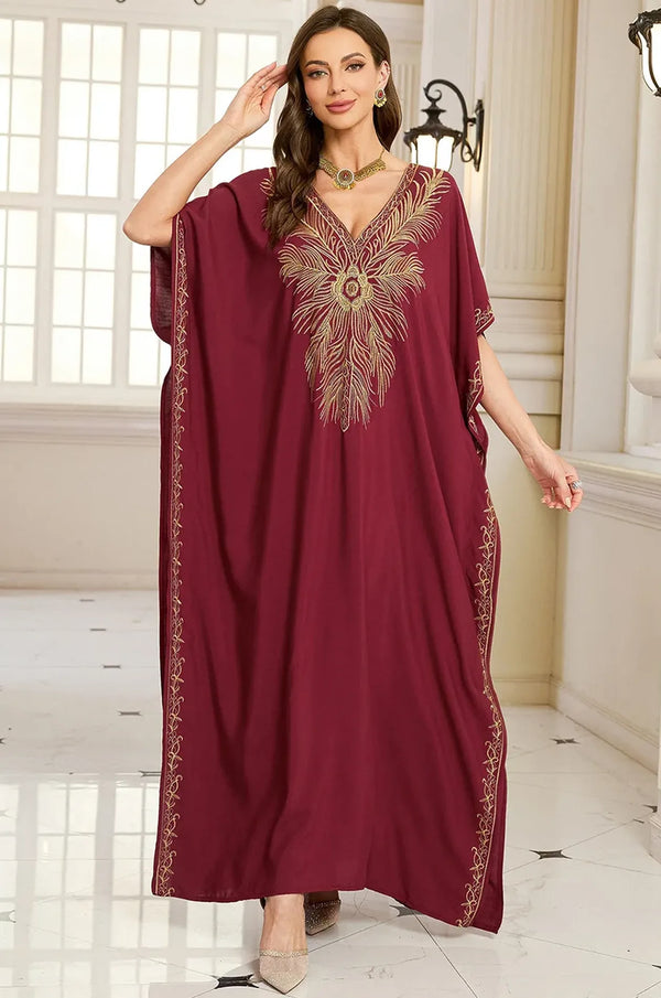 Naylara Laurel burgundy red kaftan with gold feather embroidery and gold jewelry — palace lifestyle